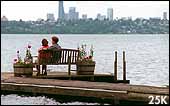 Photo of couple looking across water at Seattle